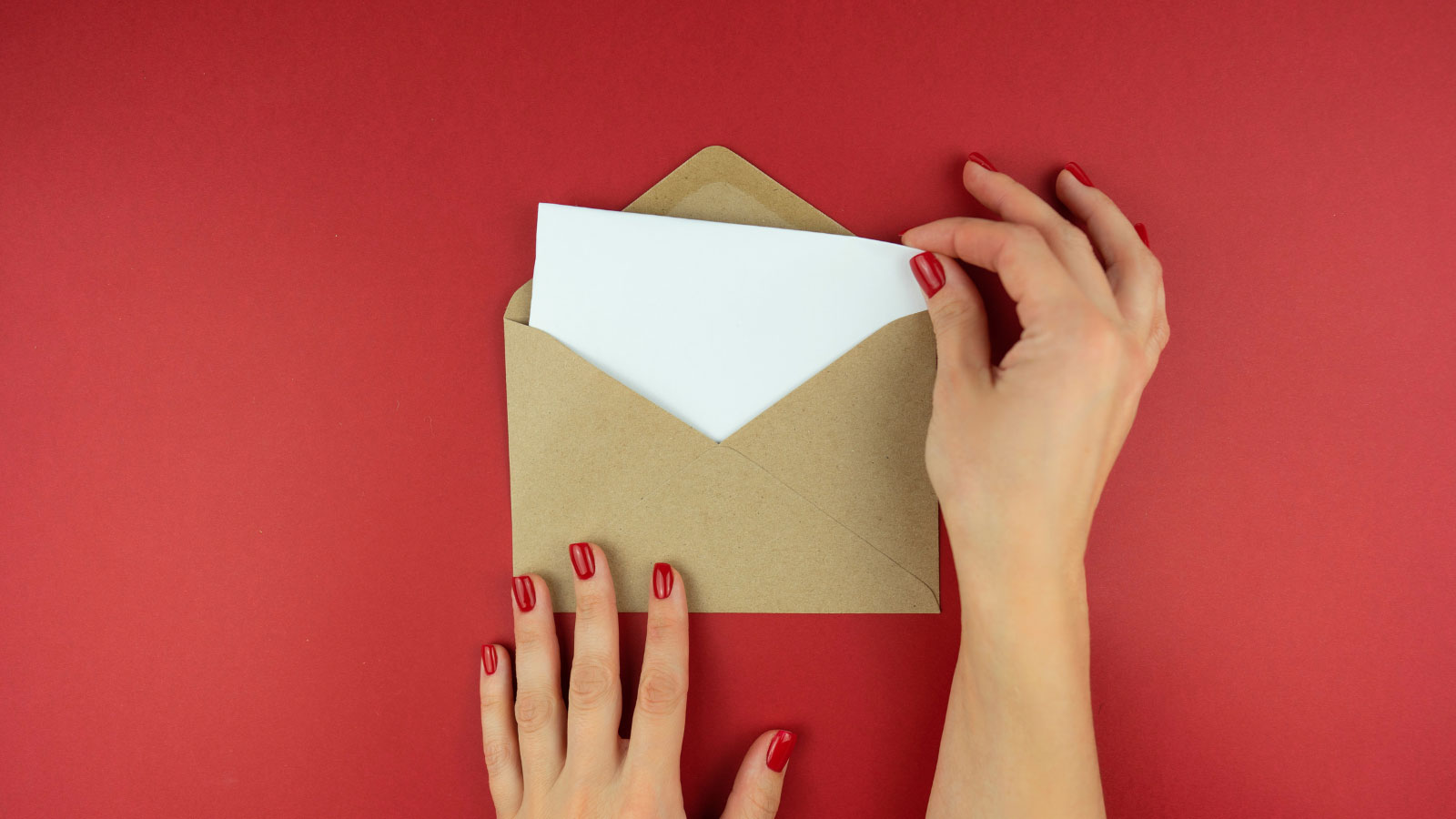 Hands opening an envelope