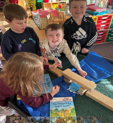 Photo of children with books and props