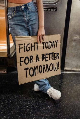 Person holding sign that says Fight today for a Better Tomorrow