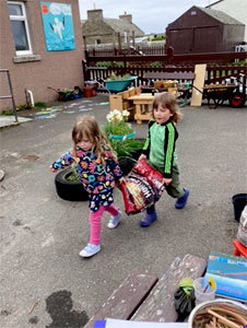 Two children carrying bag