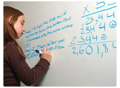 Pupil writing on whiteboard